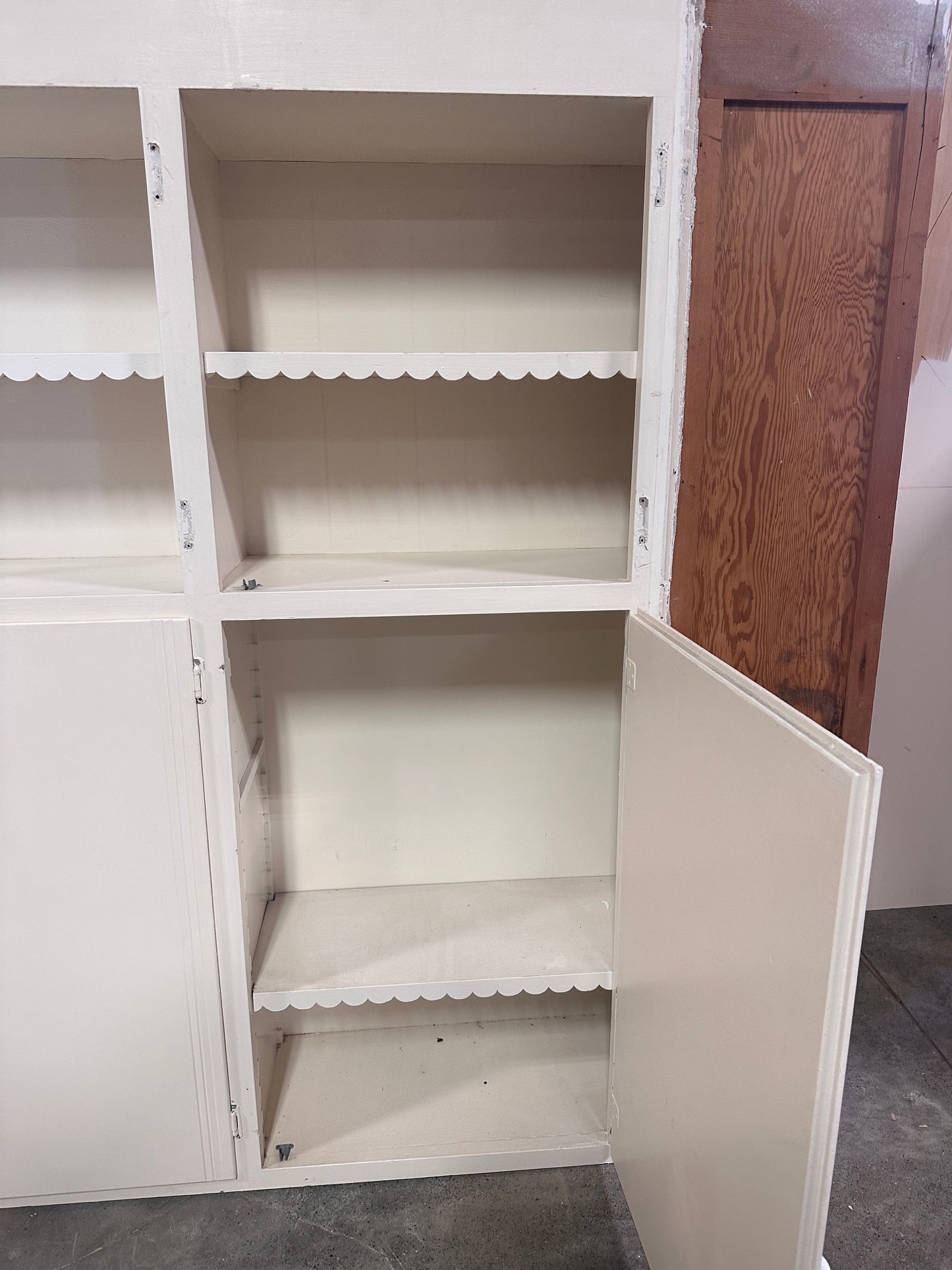 White cabinet with scalloped detailing