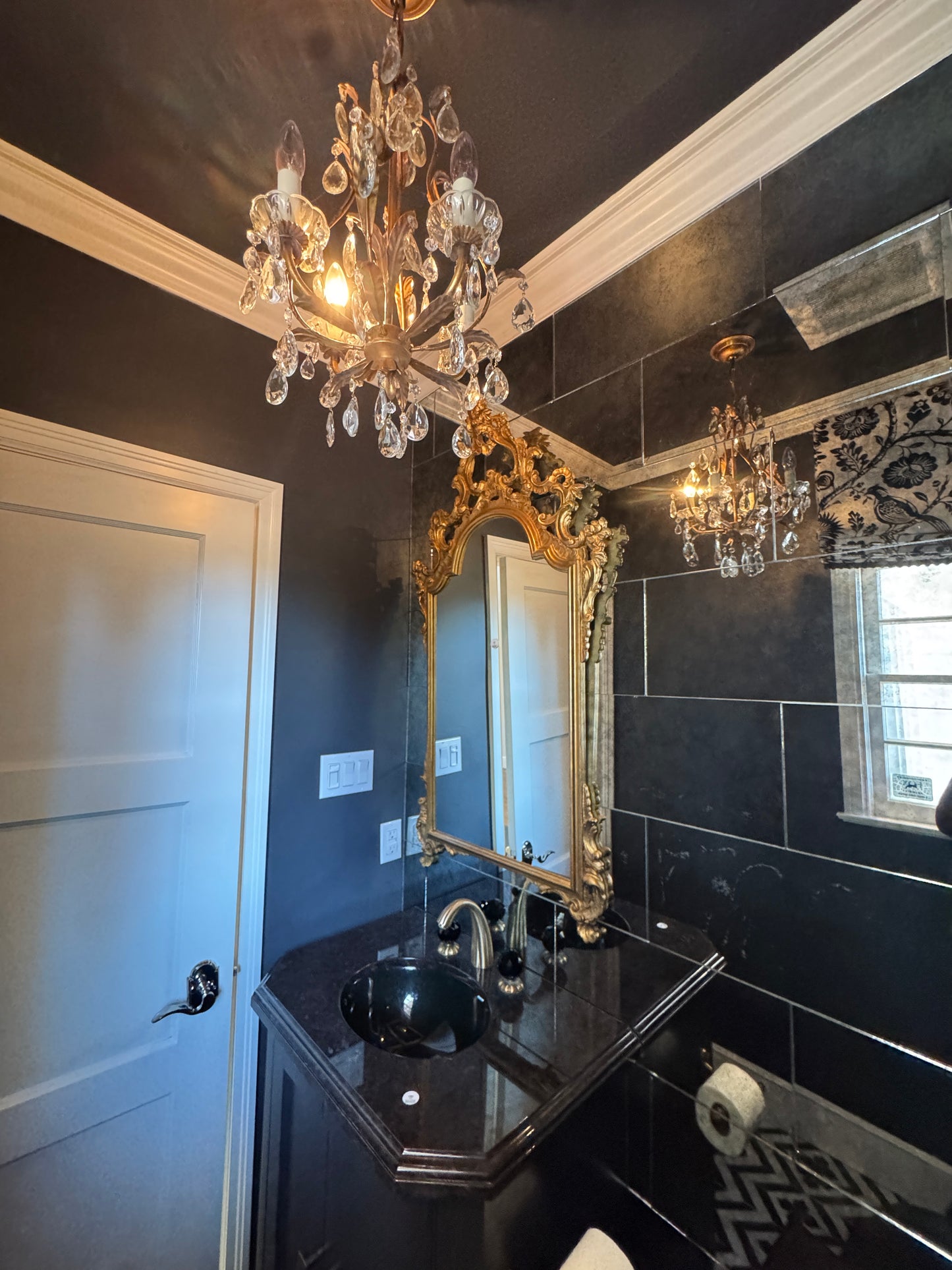 Black vanity with Jorger Florale widespread lavatory faucet and black crystal knobs