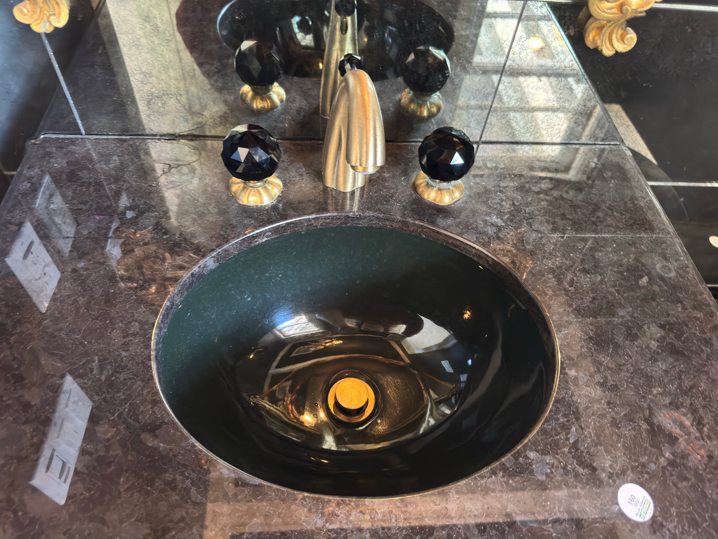 Black vanity with Jorger Florale widespread lavatory faucet and black crystal knobs