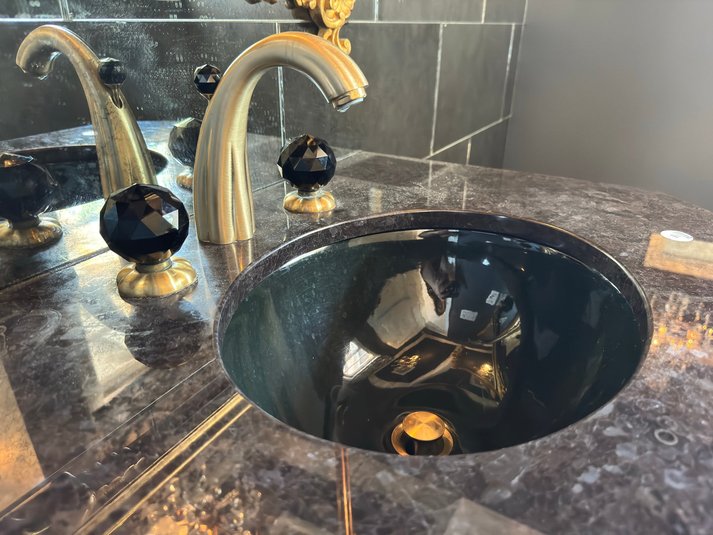 Black vanity with Jorger Florale widespread lavatory faucet and black crystal knobs
