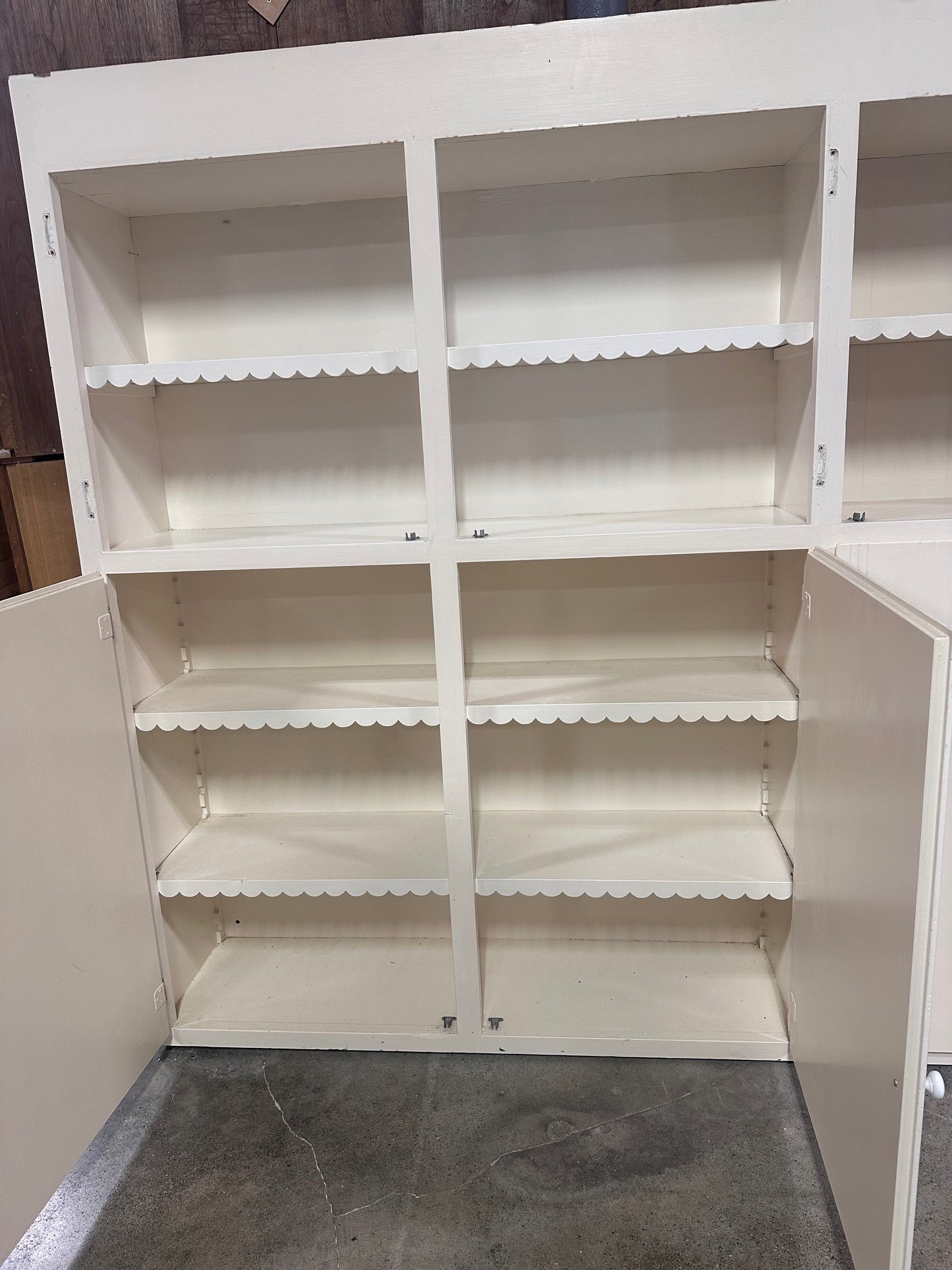 White cabinet with scalloped detailing