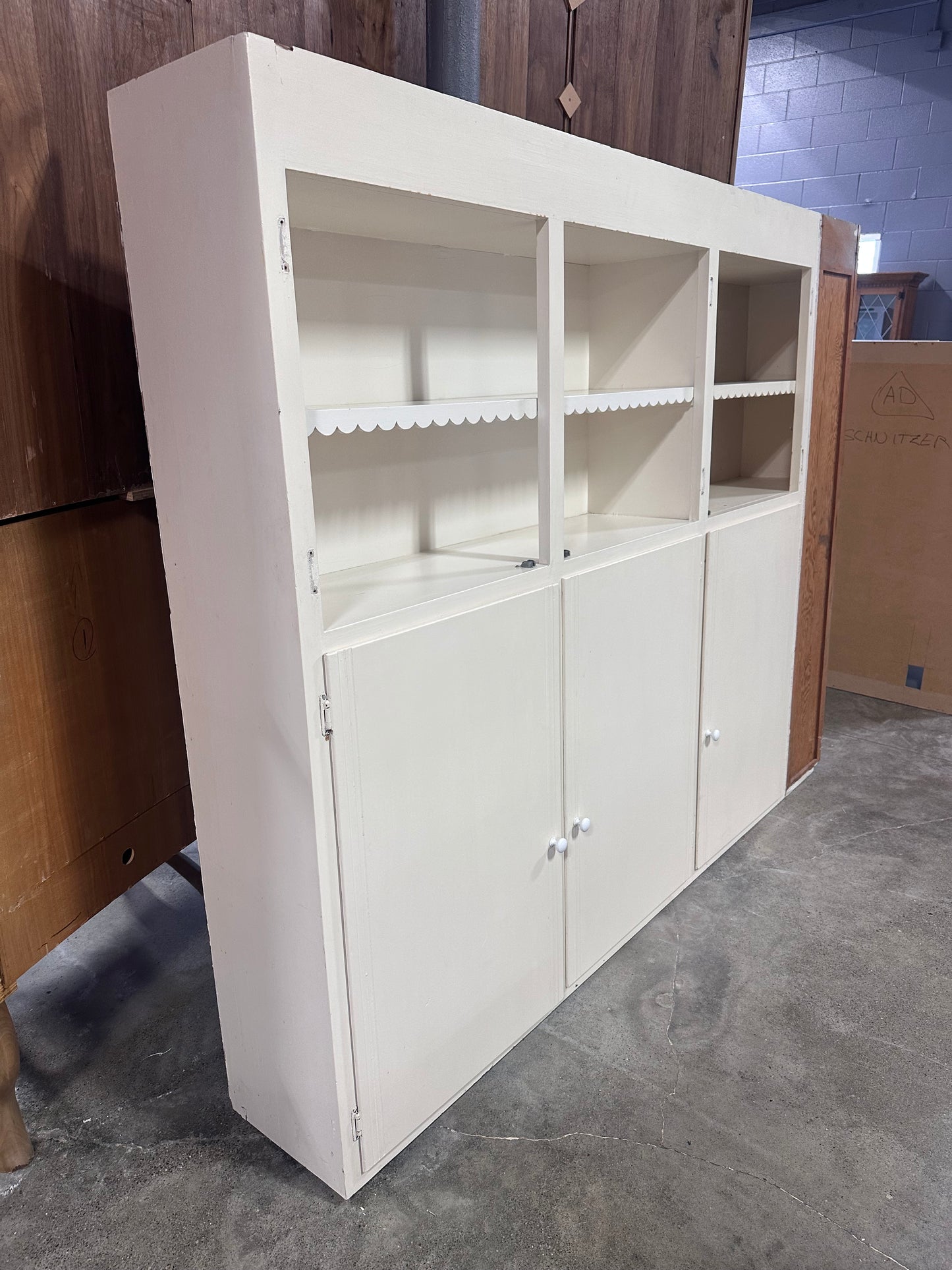 White cabinet with scalloped detailing